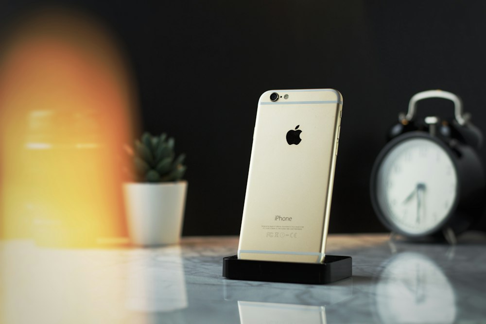 gold iPhone 6 on white surface